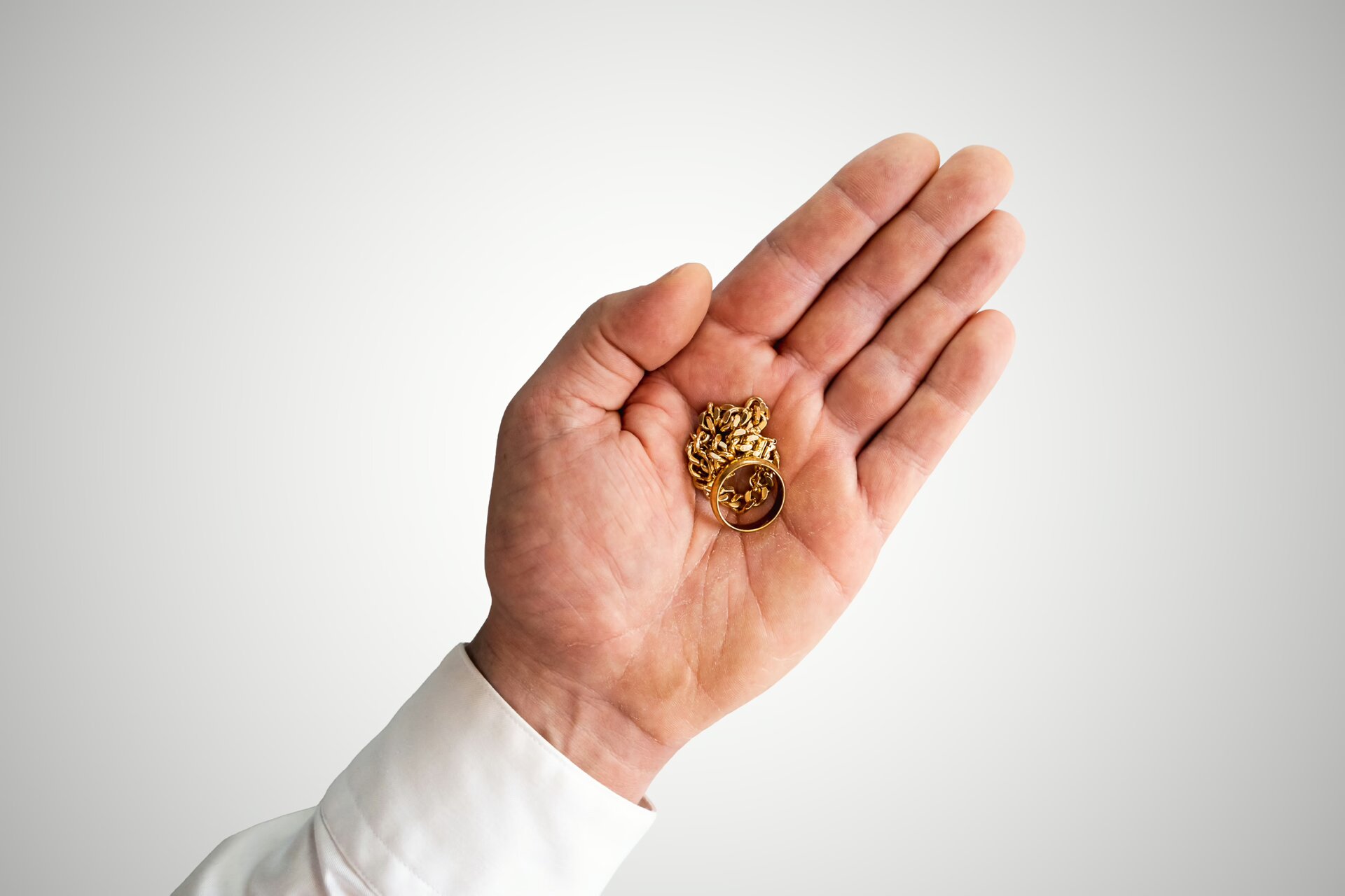 Gold chains in a buyer's palm